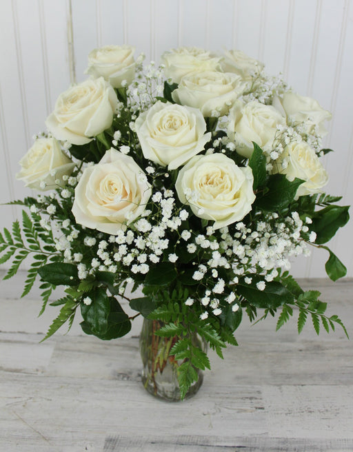 One Dozen Forever Roses with Baby's Breath in a vase